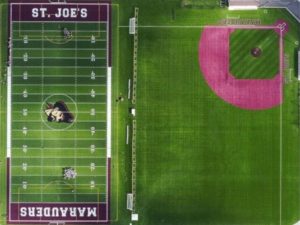 This aerial photo shows a well-maintained multi-sport athletic facility branded for St. Joe’s and their sports teams, the Marauders